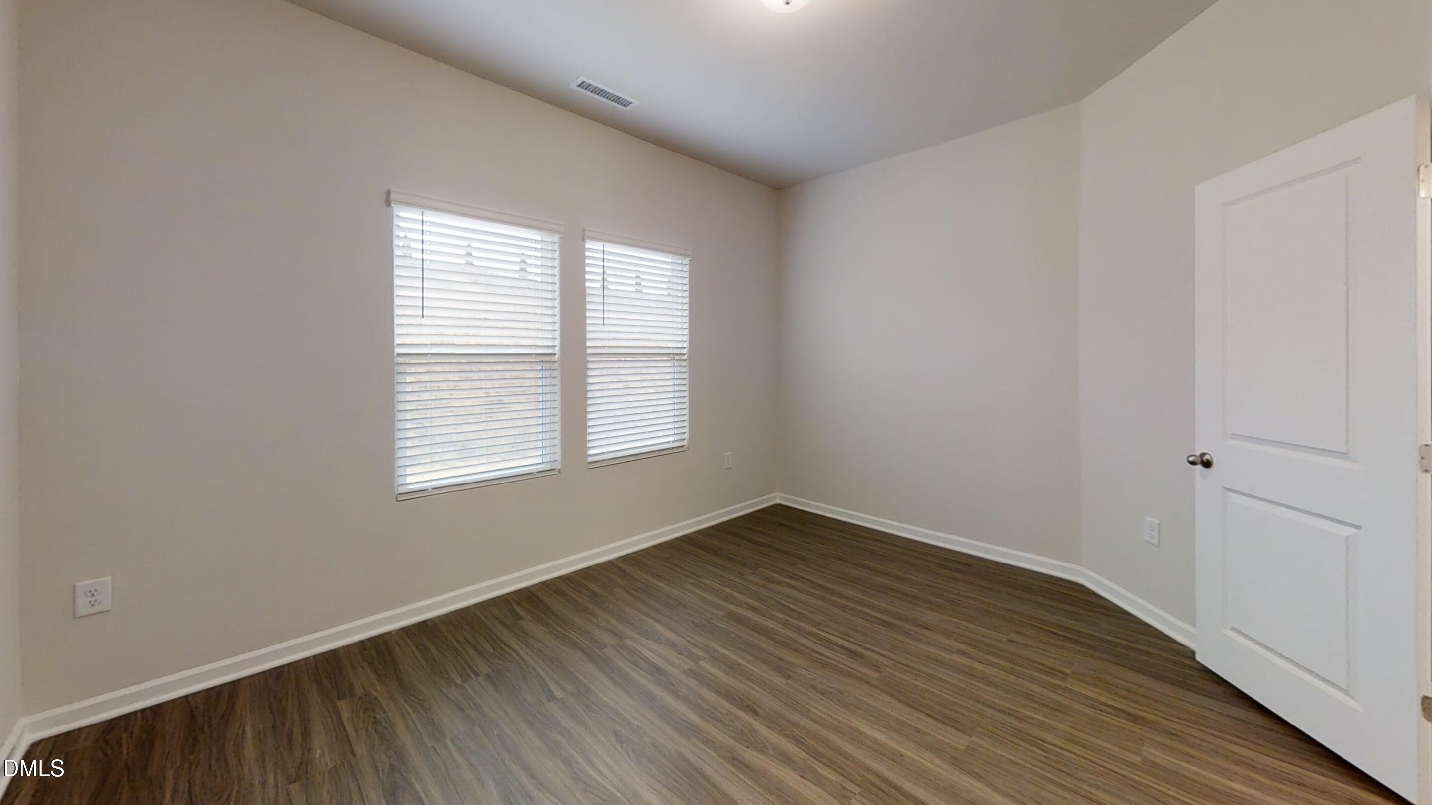 46 Coffee Tree Circle Clayton, NC 27527 - Photo 42 of 46 an empty room with wooden floor and windows