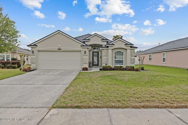 a front view of a house with a yard and garage