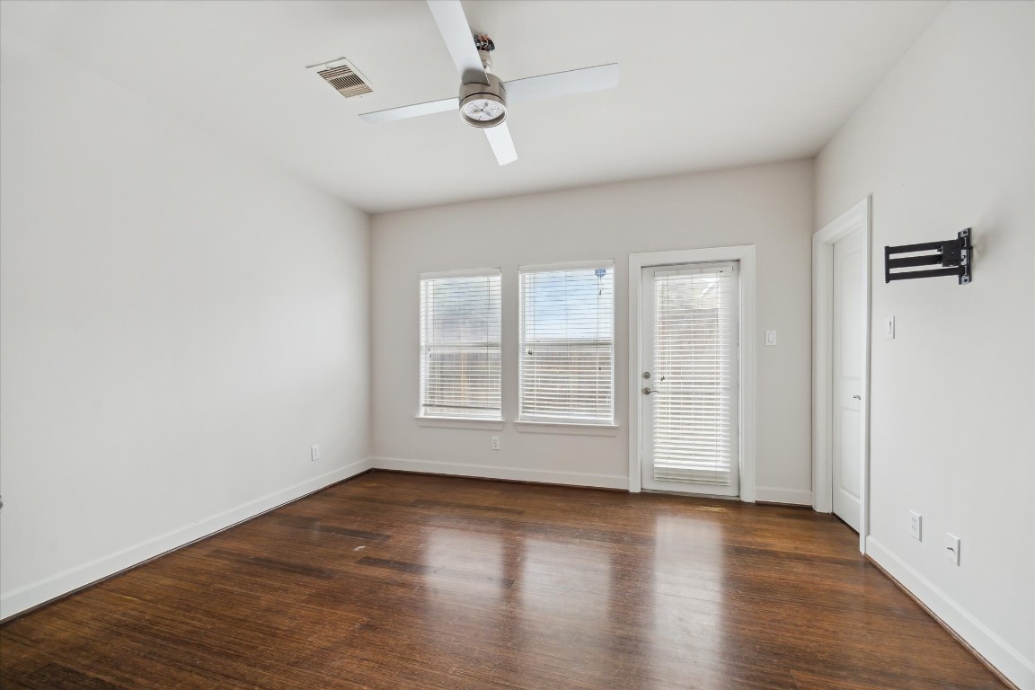 3041 Clinton Drive Houston, TX 77020 - Photo 11 of 29 an empty room with wooden floor and windows