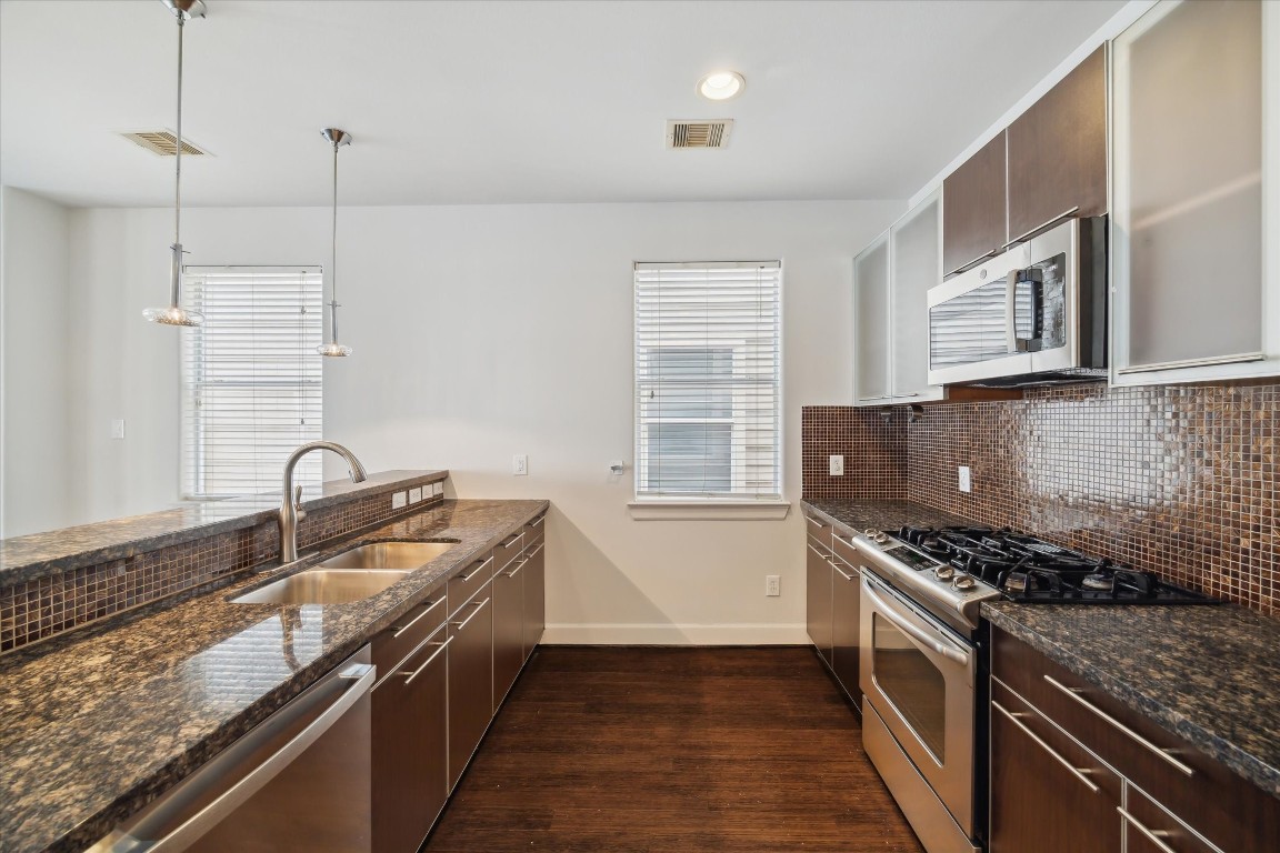 3041 Clinton Drive Houston, TX 77020 - Photo 12 of 29 a kitchen with stainless steel appliances granite countertop a sink stove and cabinets