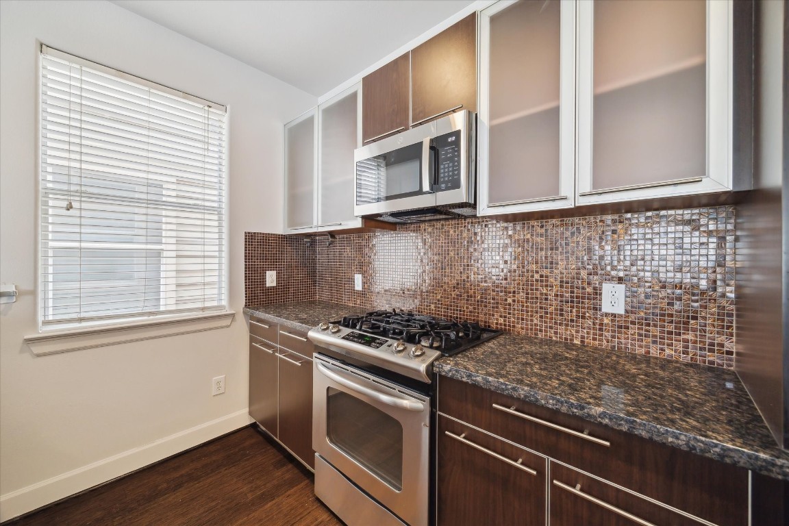 3041 Clinton Drive Houston, TX 77020 - Photo 13 of 29 a kitchen with granite countertop cabinets stainless steel appliances and wooden floor