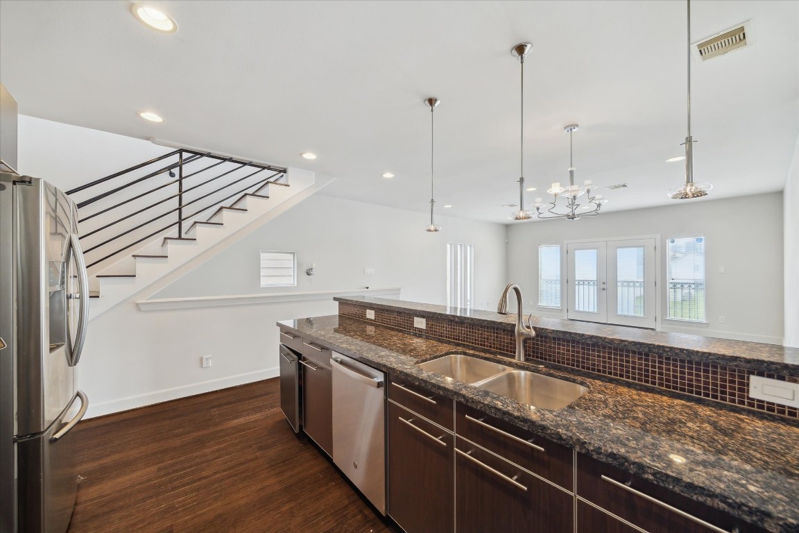 3041 Clinton Drive Houston, TX 77020 - Photo 14 of 29 a kitchen with stainless steel appliances granite countertop a sink a stove and a wooden floor