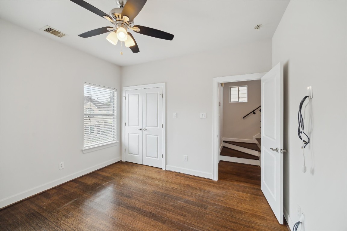 3041 Clinton Drive Houston, TX 77020 - Photo 20 of 29 a view of an empty room with a window and wooden floor
