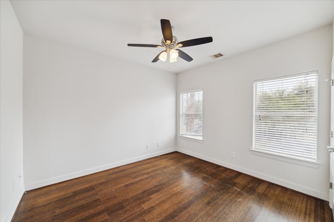 3041 Clinton Drive Houston, TX 77020 - Photo 21 of 29 a view of an empty room with wooden floor and a window