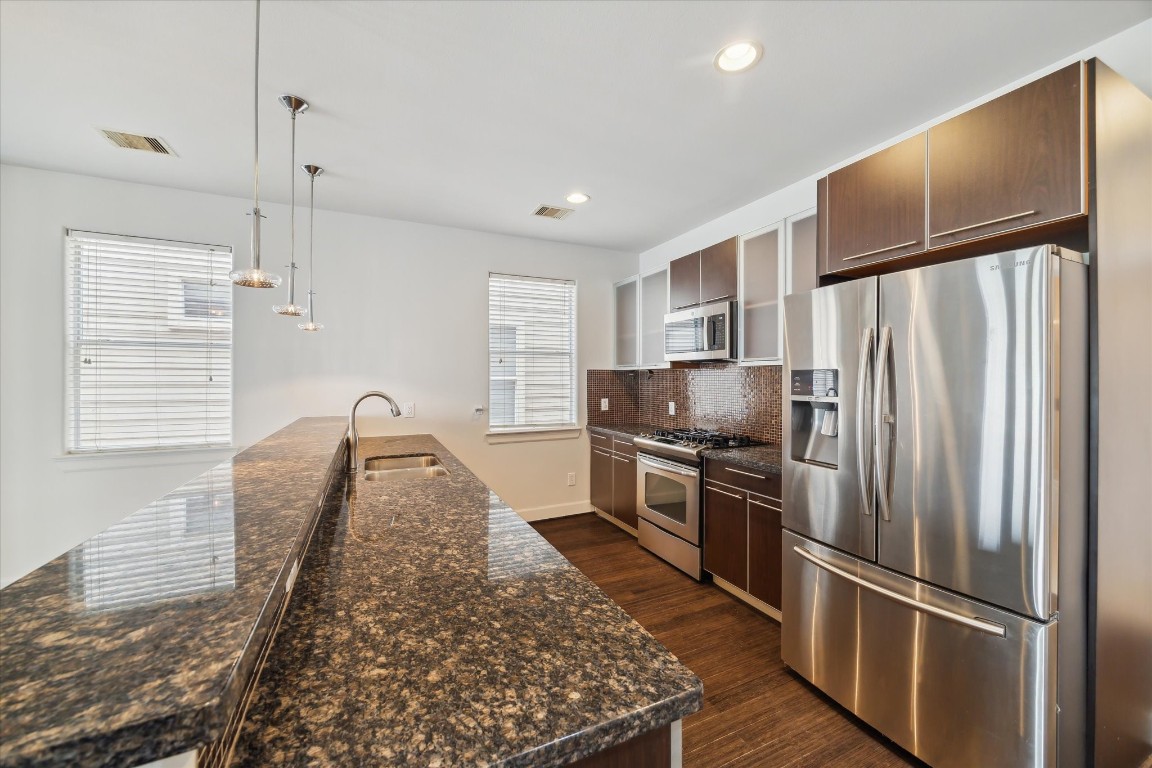 3041 Clinton Drive Houston, TX 77020 - Photo 7 of 29 a kitchen with stainless steel appliances granite countertop a refrigerator a stove and a sink