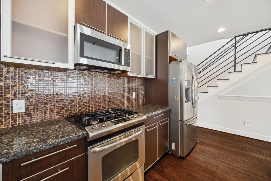 3041 Clinton Drive Houston, TX 77020 - Photo 8 of 29 a kitchen with granite countertop cabinets stainless steel appliances and wooden floor