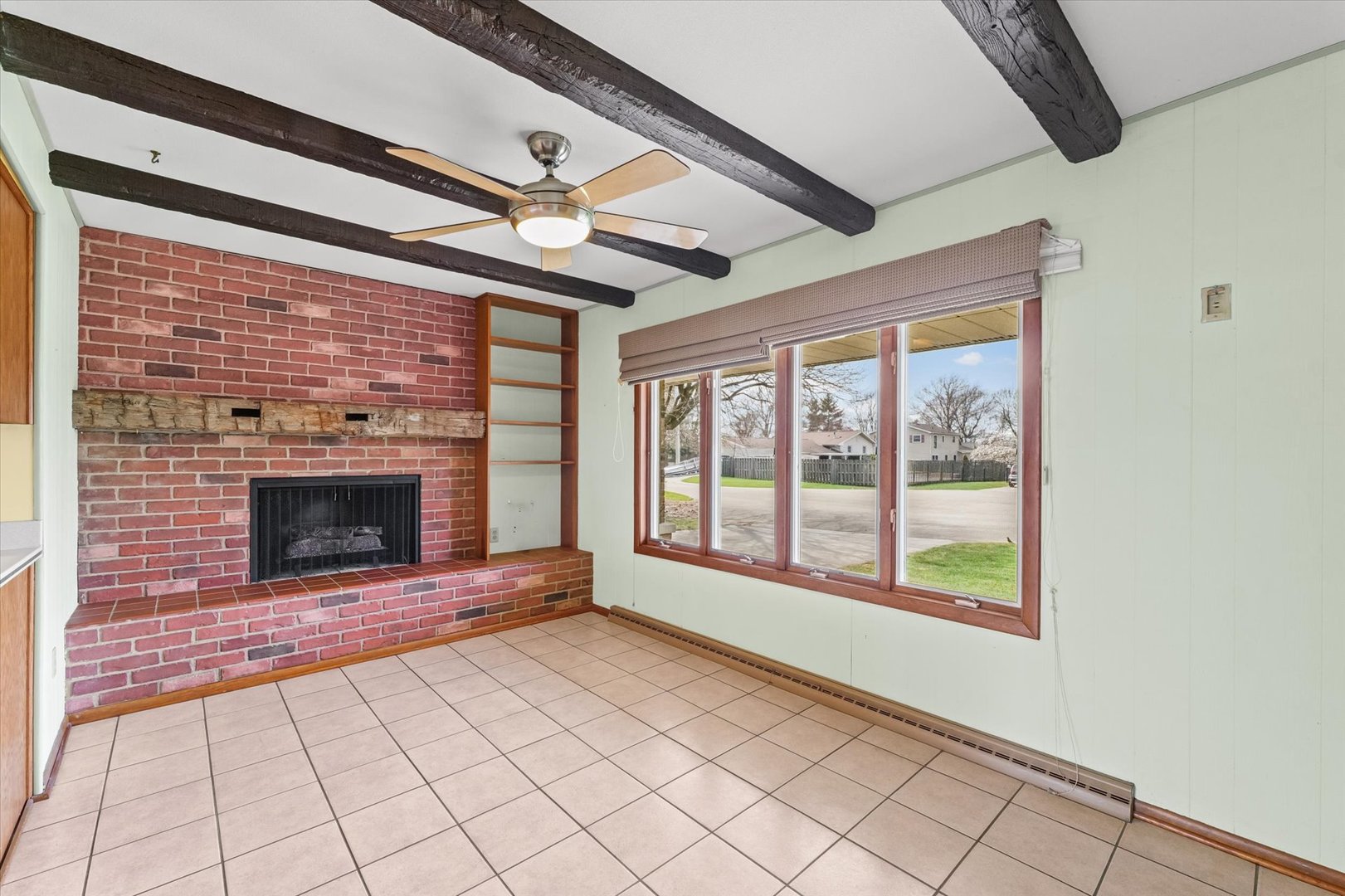 510 Parker Place Rantoul, IL 61866 - Photo 13 of 33 a view of an empty room with a fireplace and a window