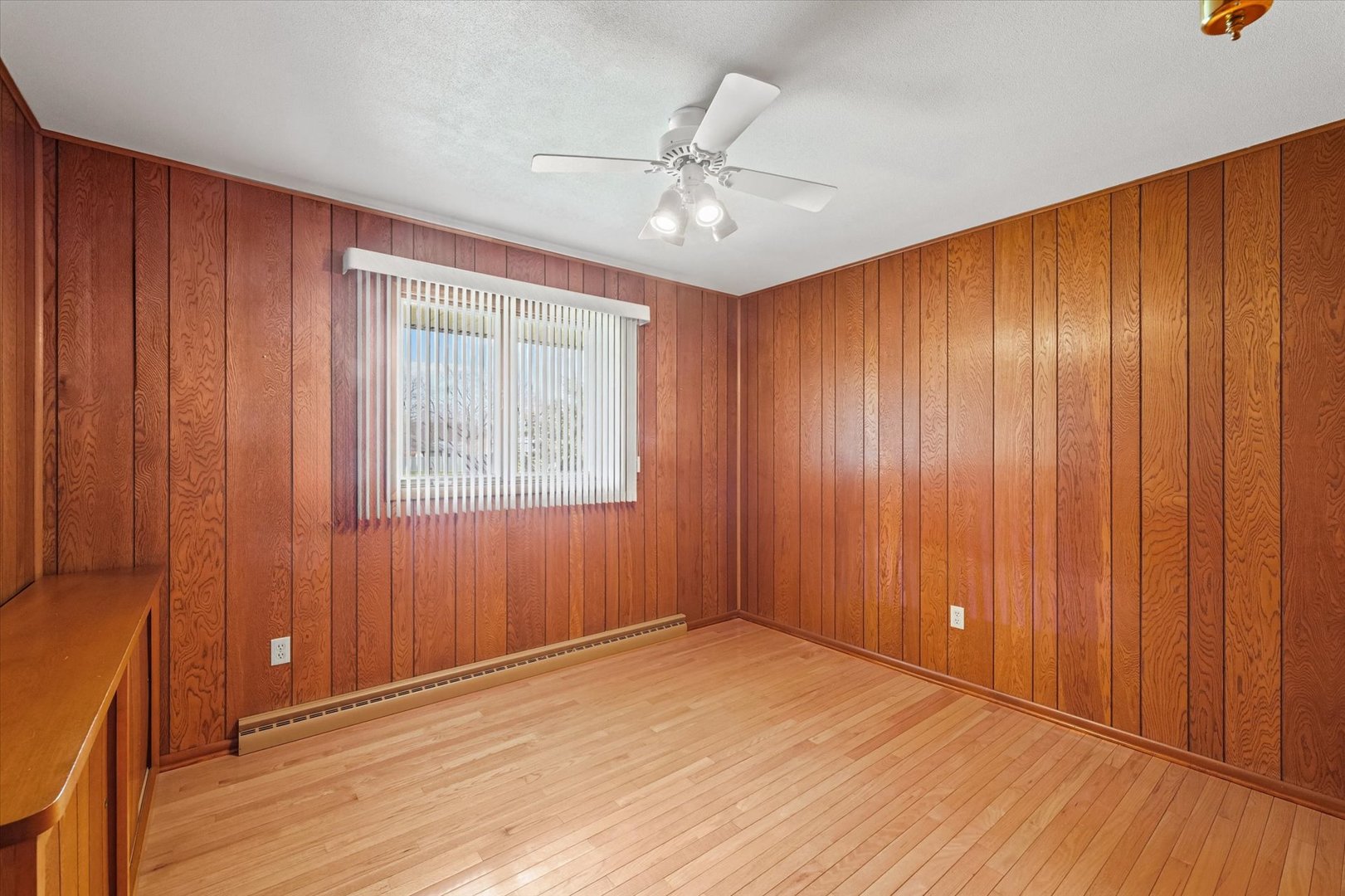 510 Parker Place Rantoul, IL 61866 - Photo 23 of 33 an empty room with wooden floor and windows with curtains