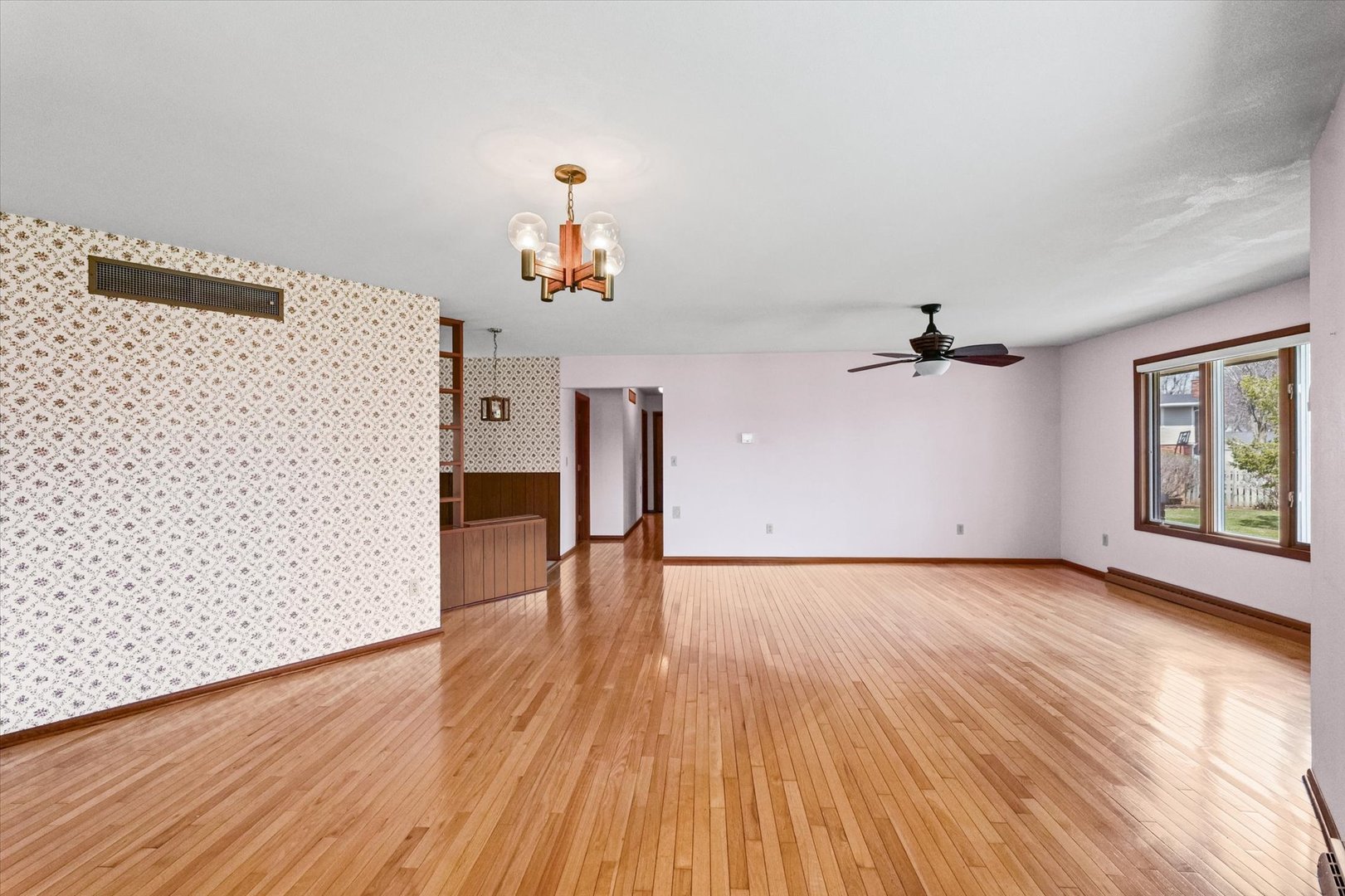 510 Parker Place Rantoul, IL 61866 - Photo 7 of 33 a view of empty room with wooden floor and fan