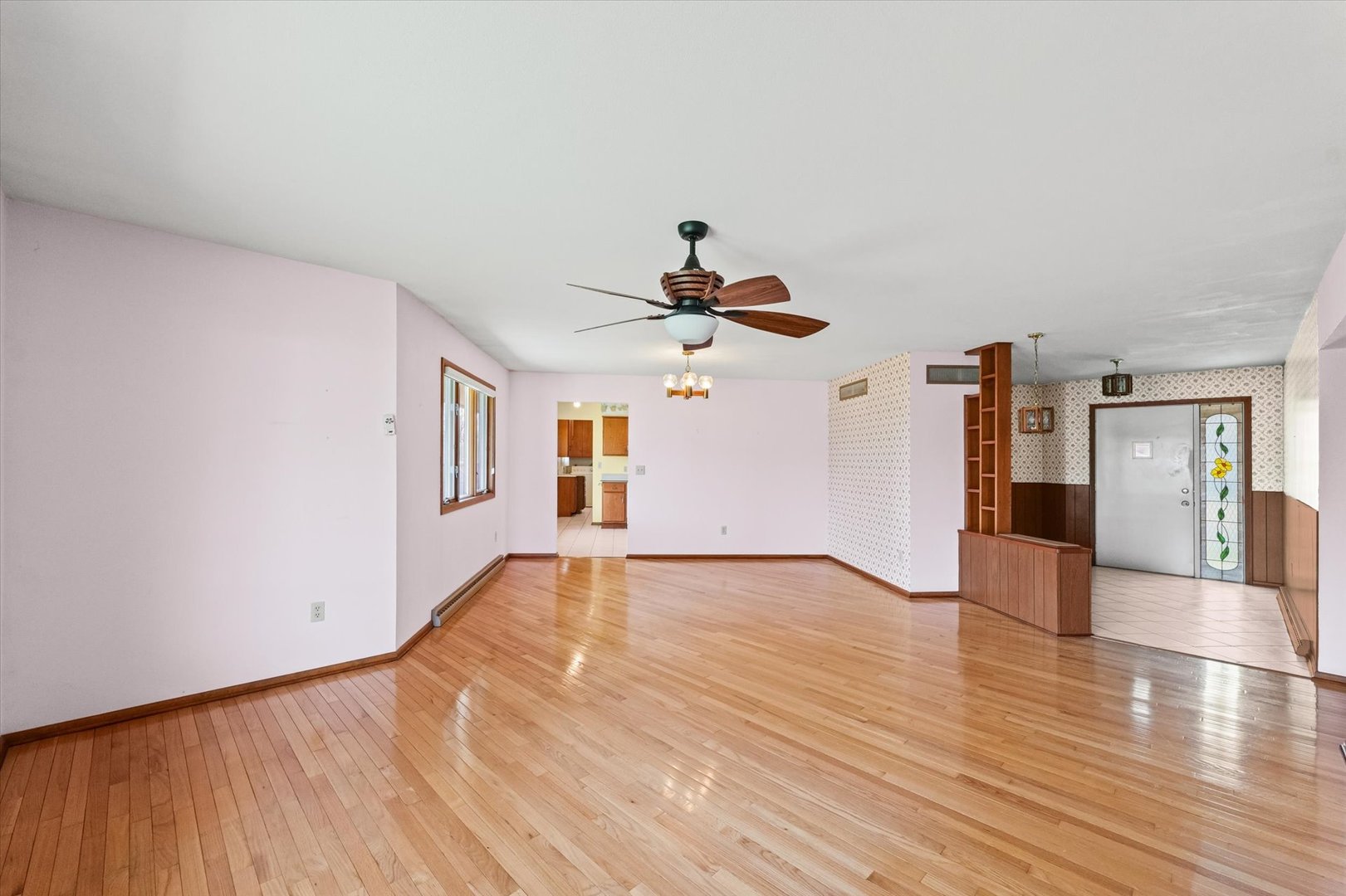 510 Parker Place Rantoul, IL 61866 - Photo 8 of 33 a view of an empty room with wooden floor and a ceiling fan