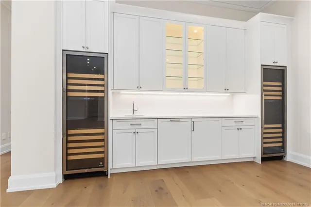 a kitchen with white cabinets and appliances
