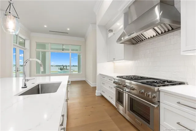 a kitchen with stainless steel appliances granite countertop a sink and a stove