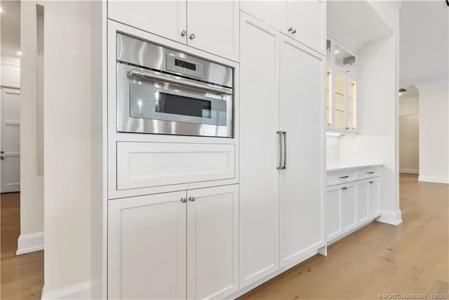 a kitchen with white cabinets and white appliances