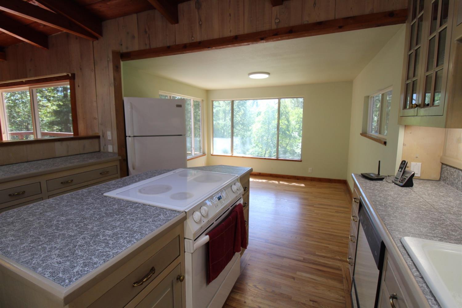 8775 North Applegate Road Grants Pass, OR 97527 - Photo 11 of 31 a kitchen with kitchen island a sink stove and wooden floor