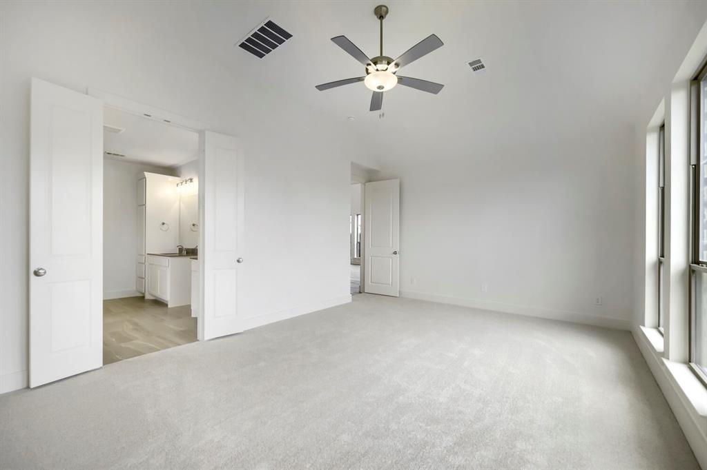 11548 Wulstone Road Haslet, TX 76052 - Photo 13 of 26 Spacious room featuring light-colored carpeting, multiple large windows, and a ceiling fan with integrated lighting