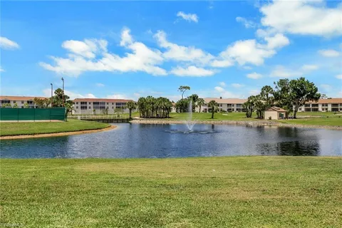 a view of a lake with houses in the background
