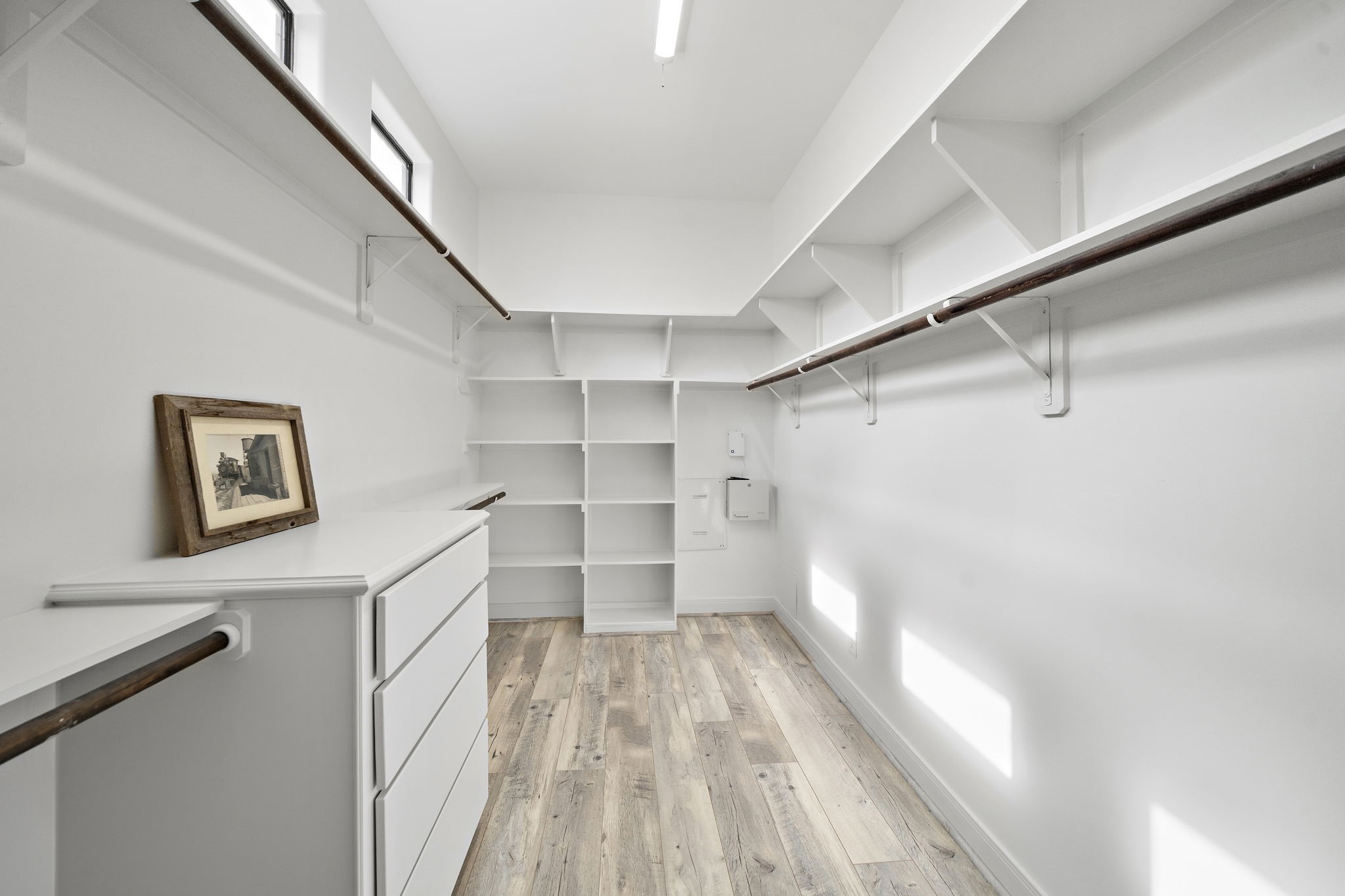 906 Reinerman Street Houston, TX 77007 - Photo 35 of 48 Spacious walk-in closet with ample shelving and hanging space, featuring bright natural light and a clean, modern design.