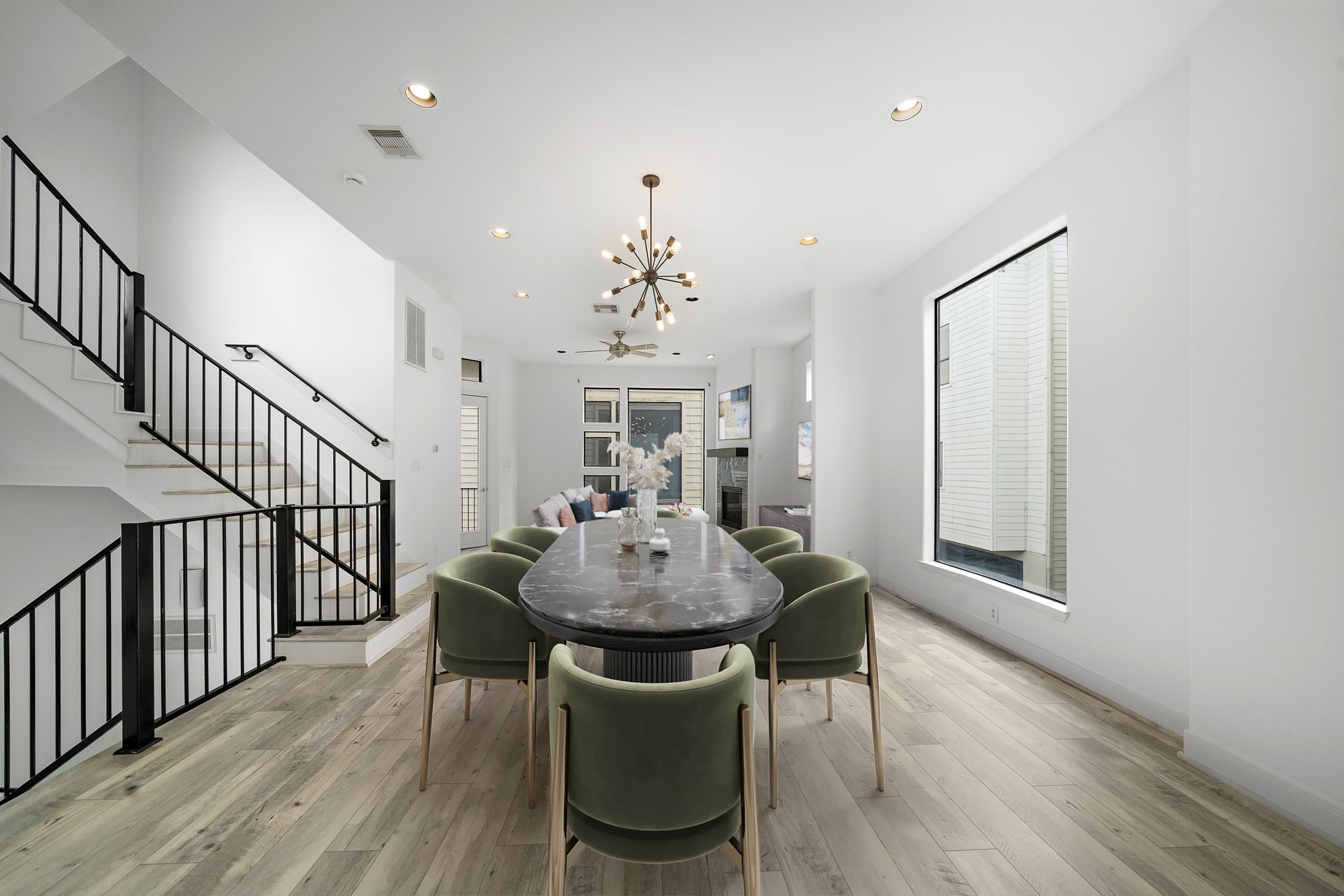 906 Reinerman Street Houston, TX 77007 - Photo 7 of 48 Discover modern elegance in this stylish dining area, boasting sleek lighting, chic furniture, and an inviting open layout ideal for entertaining.