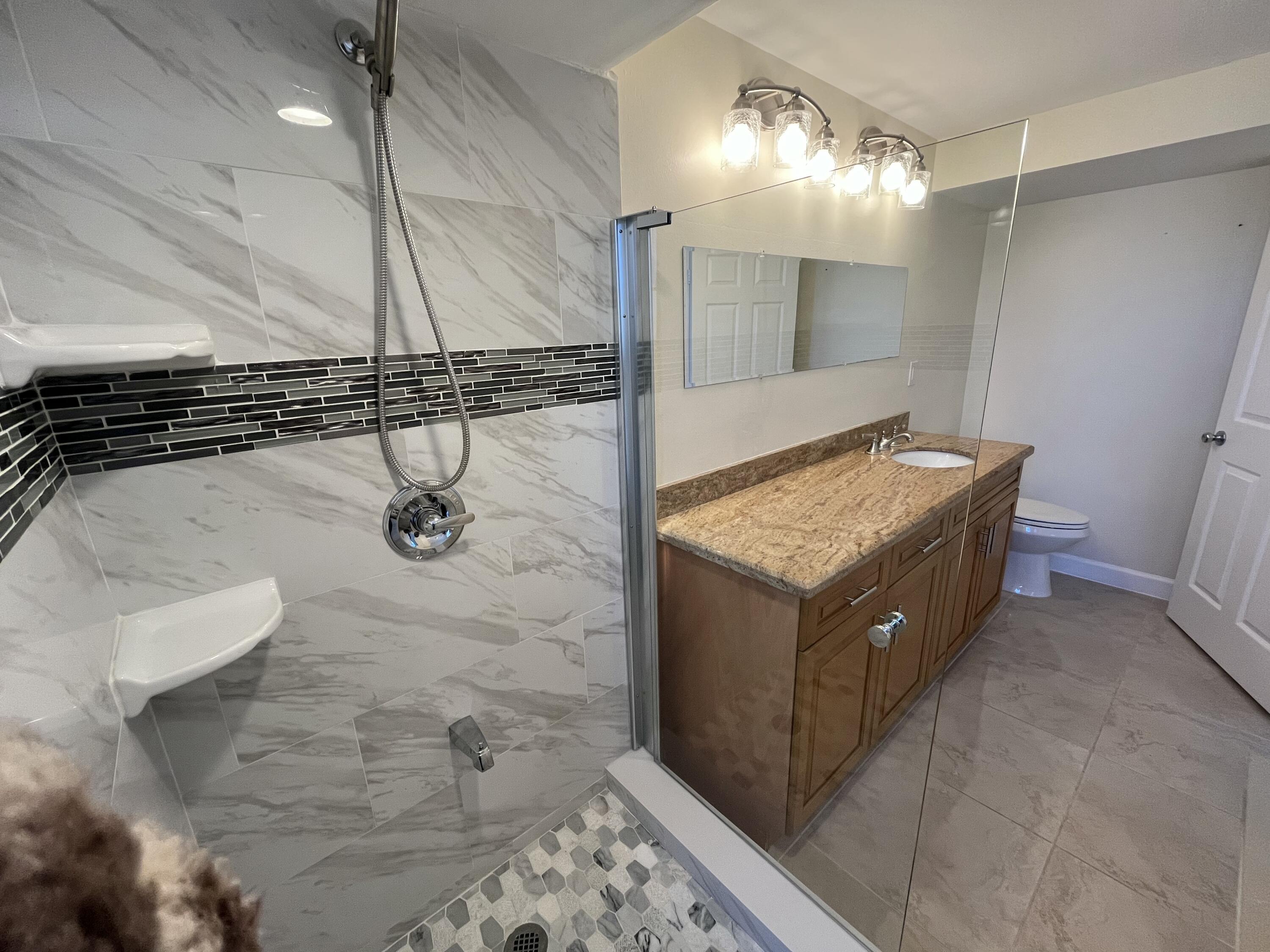 9300 Southwest 8th Street, Unit 301 Boca Raton, FL 33428 - Photo 18 of 27 a bathroom with a sink and mirror