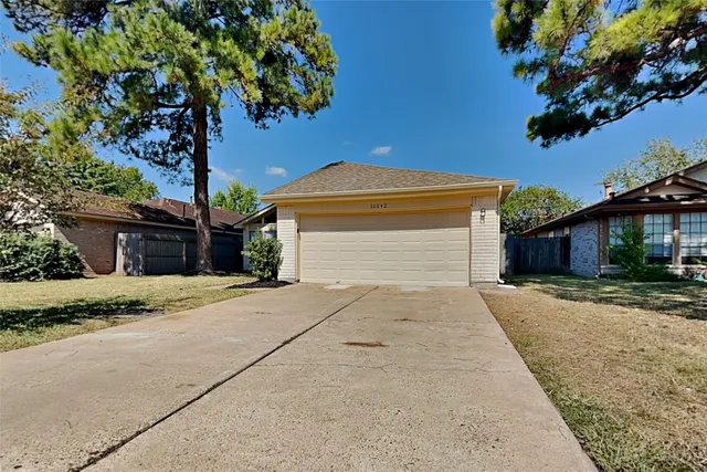 a front view of a house with a yard and a garage