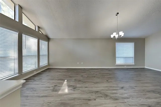 a view of a room with window wooden floor and glass door