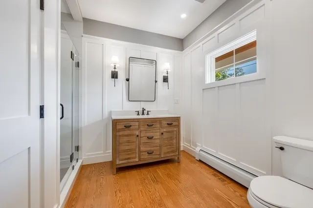 a bathroom with a granite countertop sink toilet and shower