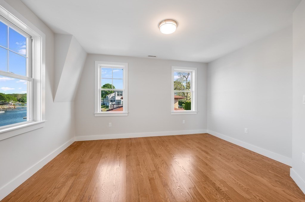 8 Riverside Road Gloucester, MA 01930 - Photo 24 of 40 an empty room with wooden floor and windows