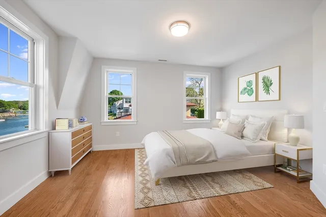 a bedroom with a bed and a large window