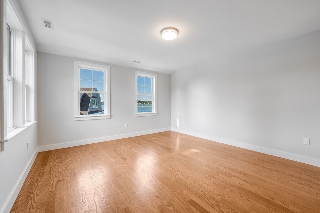 8 Riverside Road Gloucester, MA 01930 - Photo 26 of 40 an empty room with wooden floor and windows