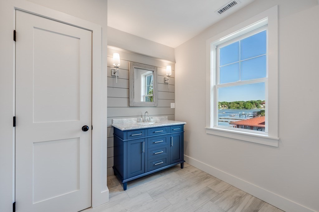 8 Riverside Road Gloucester, MA 01930 - Photo 29 of 40 a bathroom with a granite countertop sink mirror and window