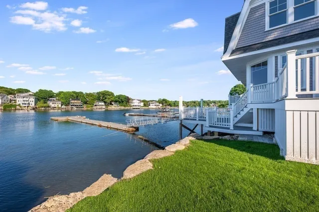 a view of a lake with a house swimming pool and outdoor space