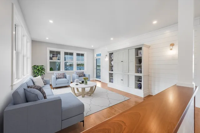 a living room with furniture and wooden floor