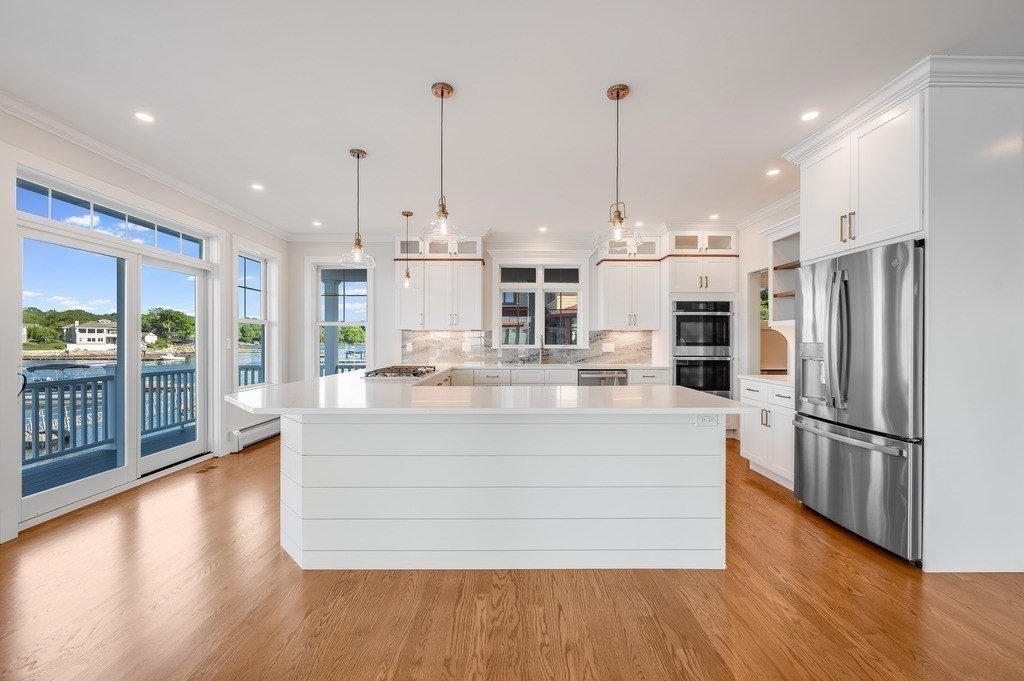 8 Riverside Road Gloucester, MA 01930 - Photo 9 of 40 a view of kitchen with stainless steel appliances kitchen island wooden floor and window