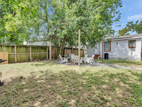 a backyard of a house with table and chairs