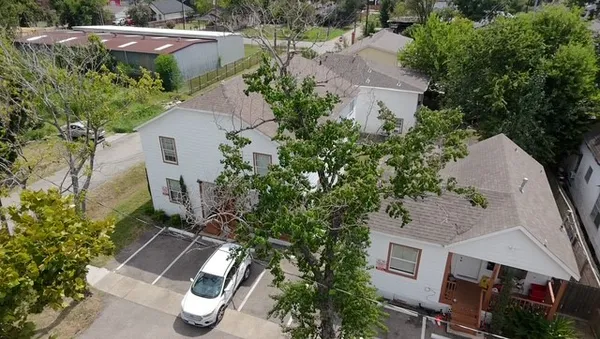 an aerial view of a house with outdoor space and street view