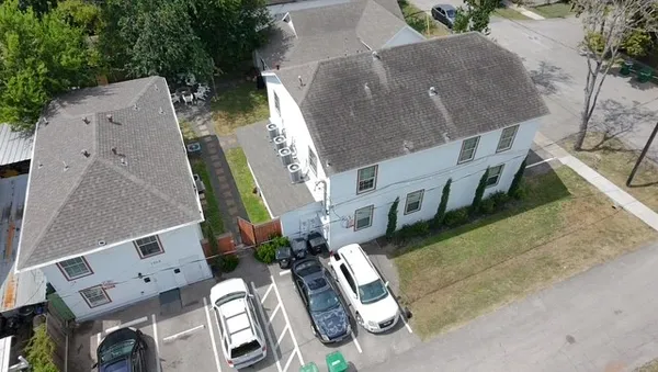 an aerial view of multiple houses with outdoor space