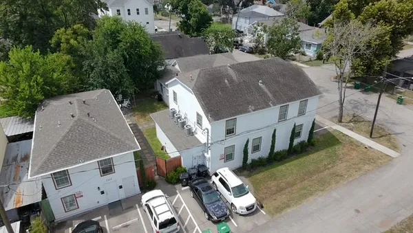 an aerial view of a house with outdoor space