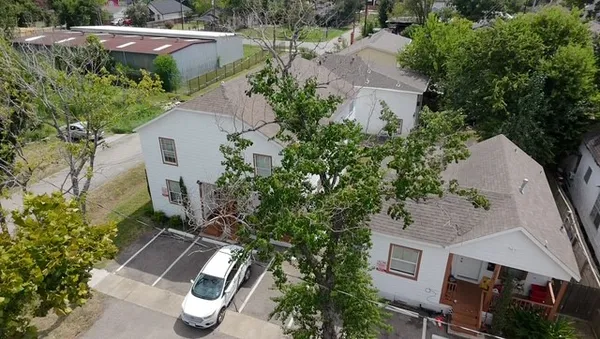 an aerial view of multiple houses with yard