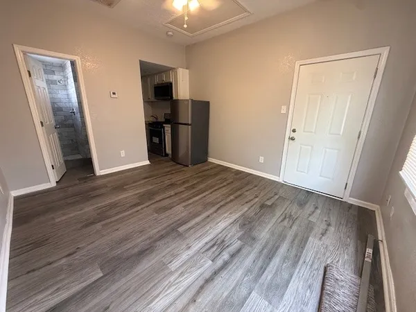 wooden floor in an empty room with a fireplace