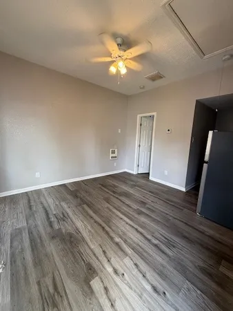 a view of an empty room and wooden floor