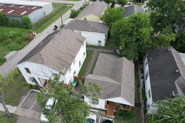 an aerial view of a house with a yard and trees