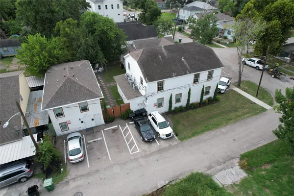 an aerial view of a house with garden space and street view
