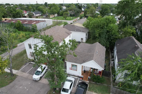 an aerial view of a house with garden space and street view
