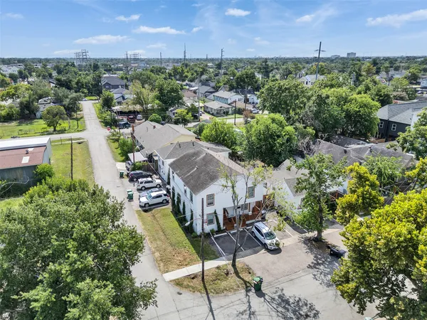 an aerial view of a house with garden space and street view