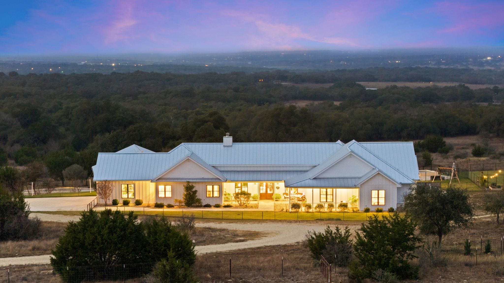 452 Southwick Ranch Road Johnson City, TX 78636 - Photo 2 of 30 a view of a big house with a big yard and large trees