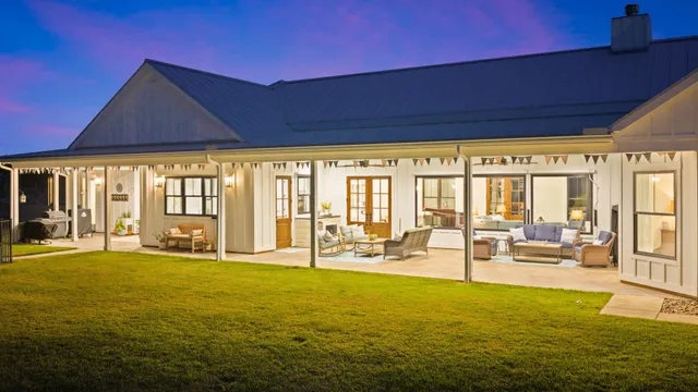 a living room with furniture and floor to ceiling windows