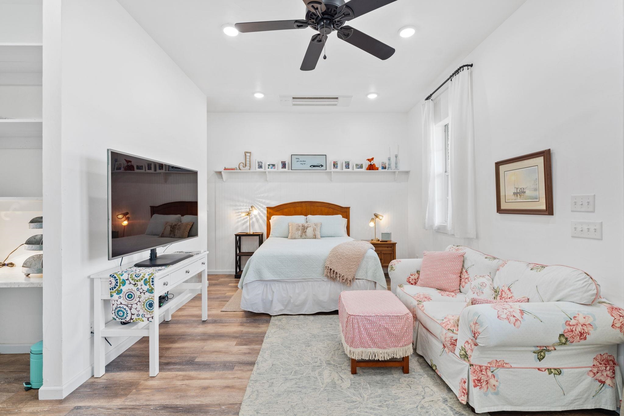 452 Southwick Ranch Road Johnson City, TX 78636 - Photo 28 of 30 a bedroom with furniture and a flat screen tv