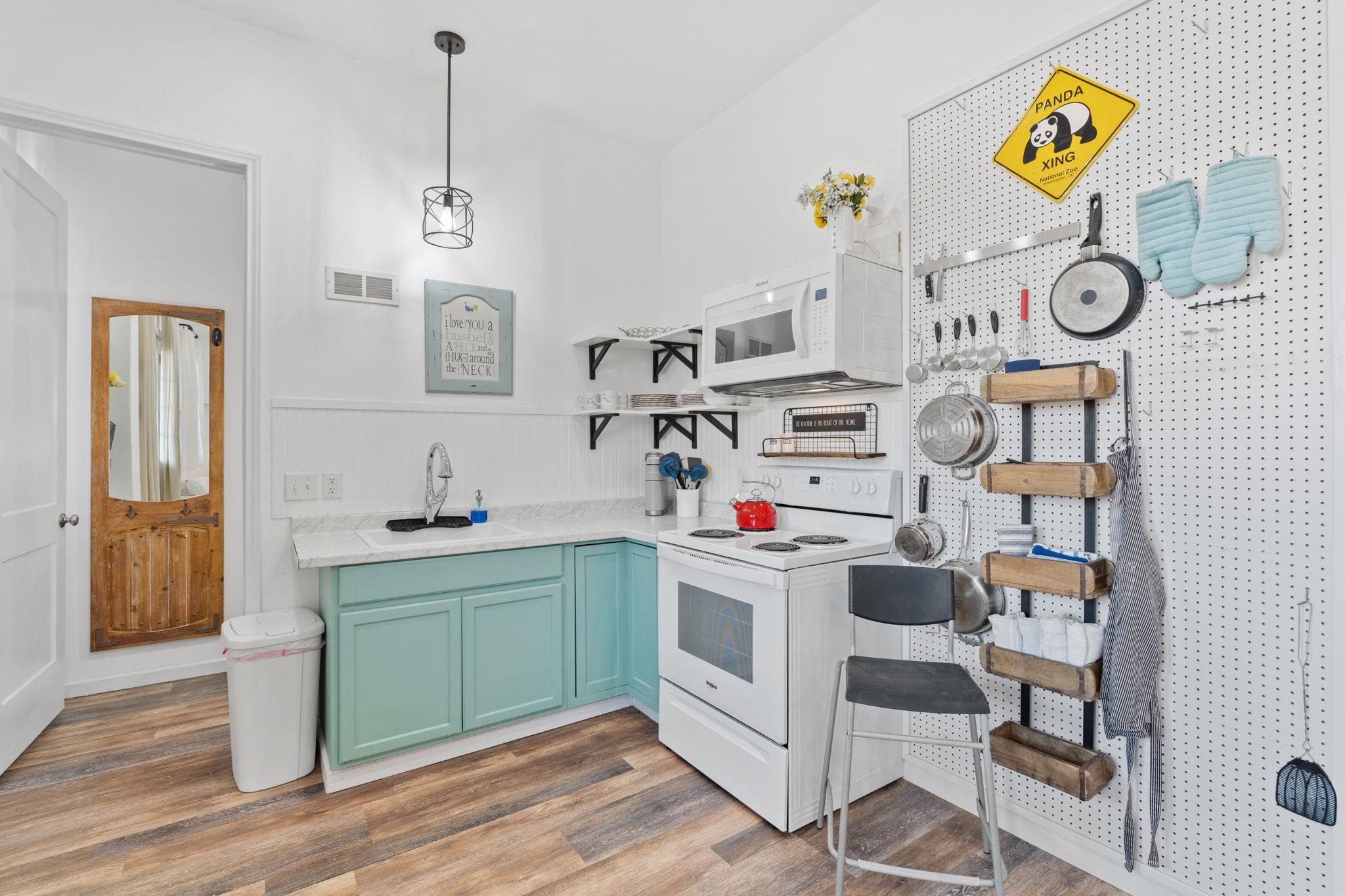 452 Southwick Ranch Road Johnson City, TX 78636 - Photo 29 of 30 a utility room with cabinets and wooden floor