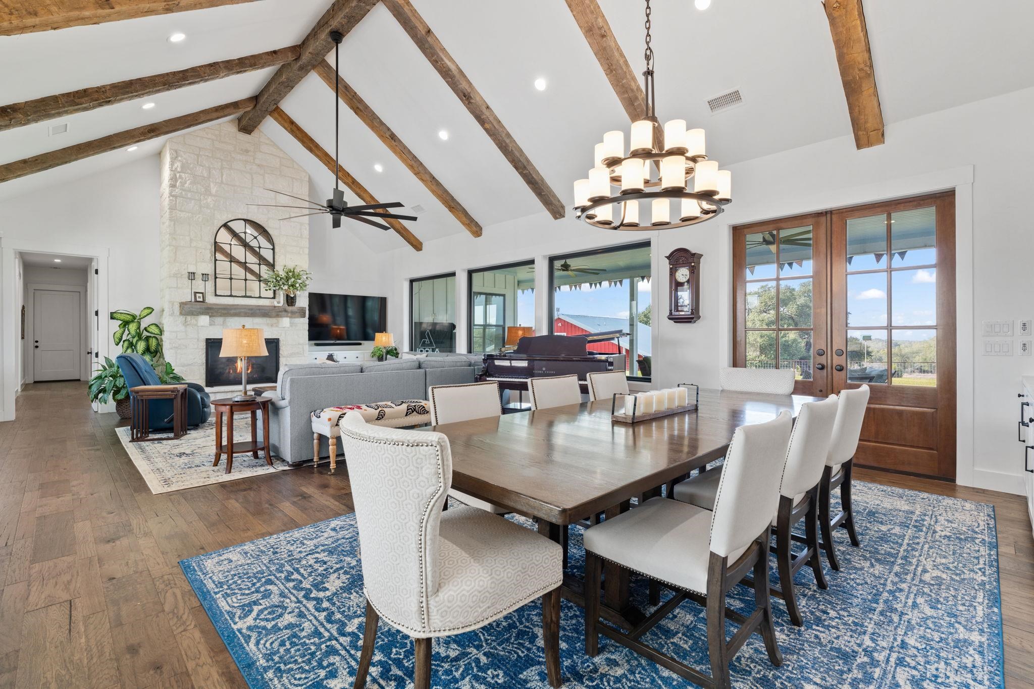 452 Southwick Ranch Road Johnson City, TX 78636 - Photo 3 of 30 a view of a dining room with furniture a chandelier and wooden floor