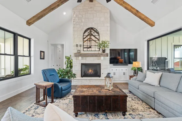 a living room with furniture a fireplace and a flat screen tv